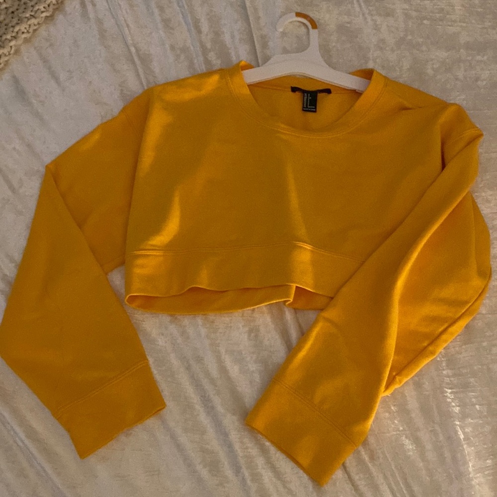 A cropped mustard yellow sweater